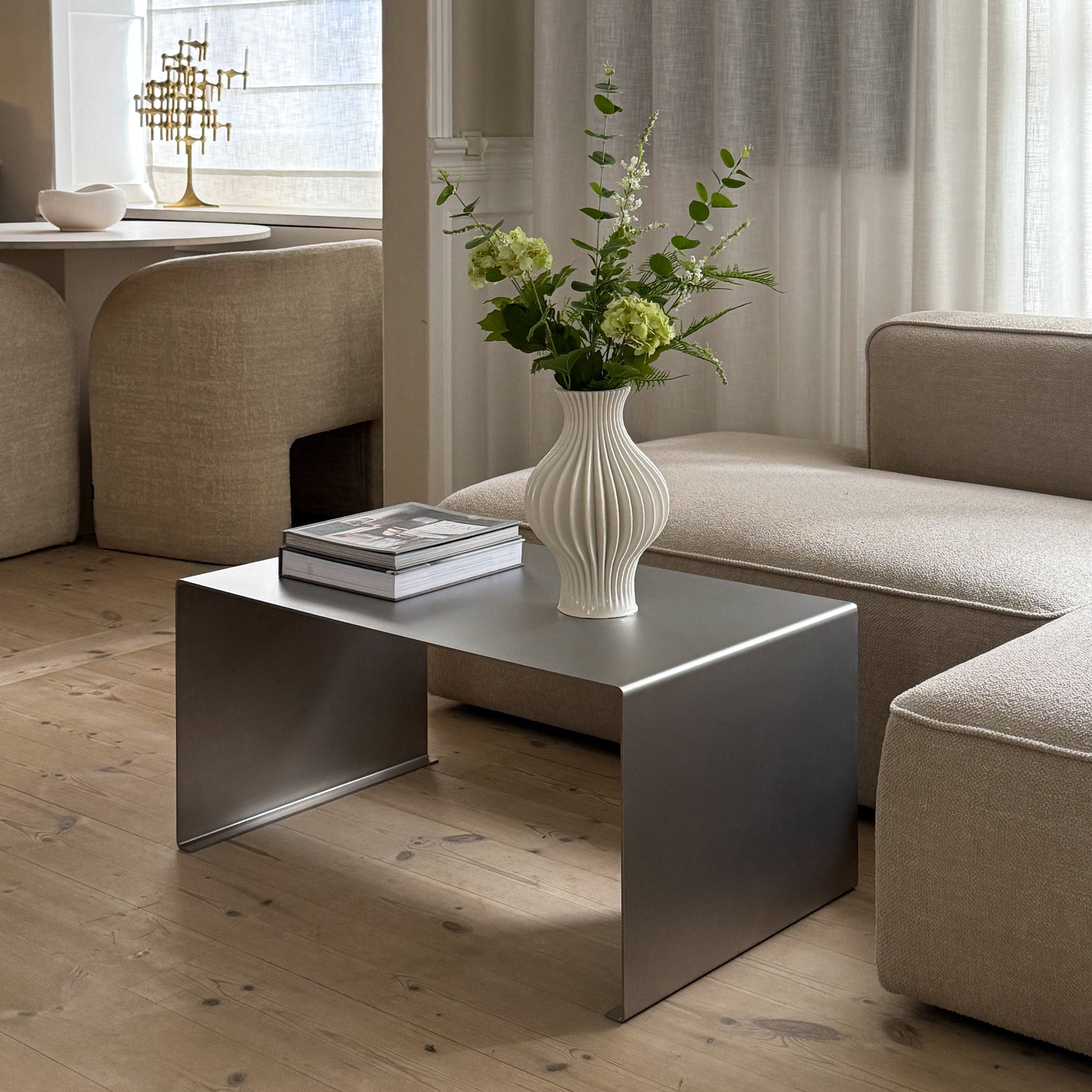 Angled view of the Elegance Coffee Table with a vase placed on top.