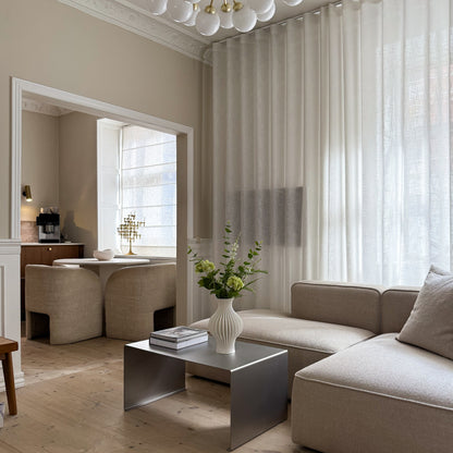 Angled composition showing the Elegance Coffee Table and more of the surrounding space.
