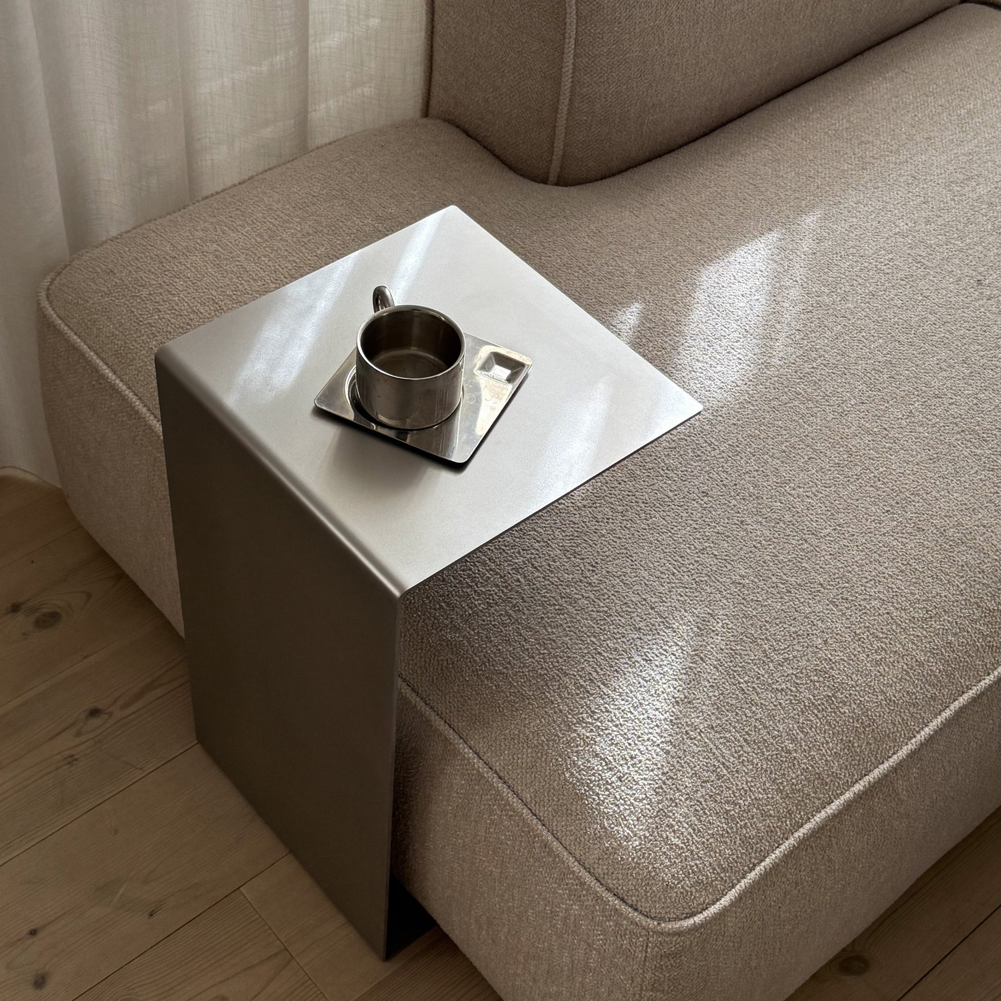 Angled view of the Elegance Side Table highlighting its satin-matte surface and proportions.